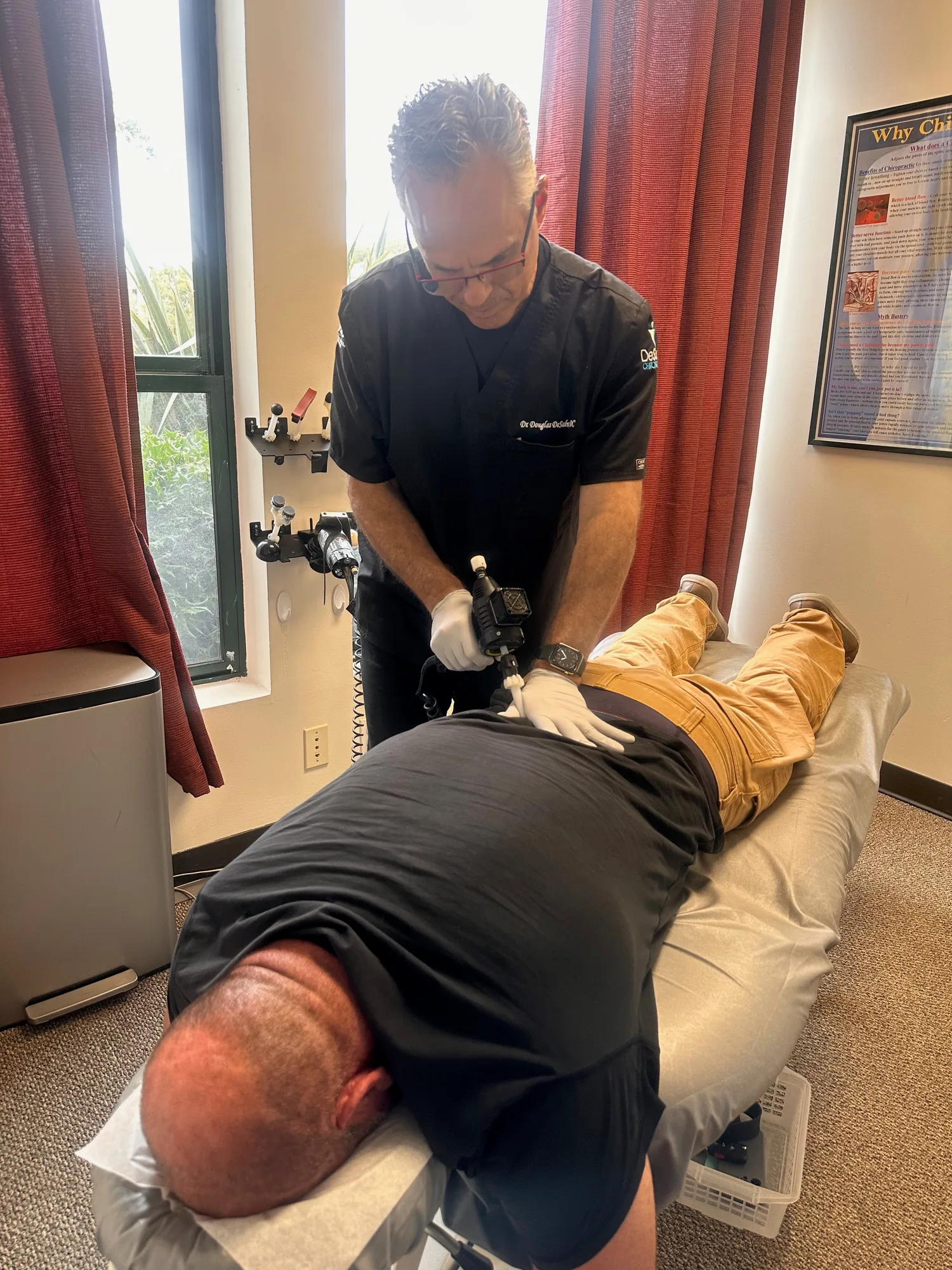 Dr. Douglas DeSalvo treating lower back pain with a hands-on chiropractic adjustment at DeSalvo Chiropractic in Novato